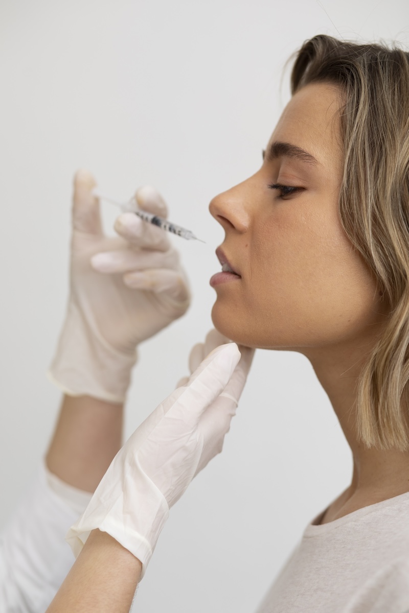 A woman receiving lip filler injections