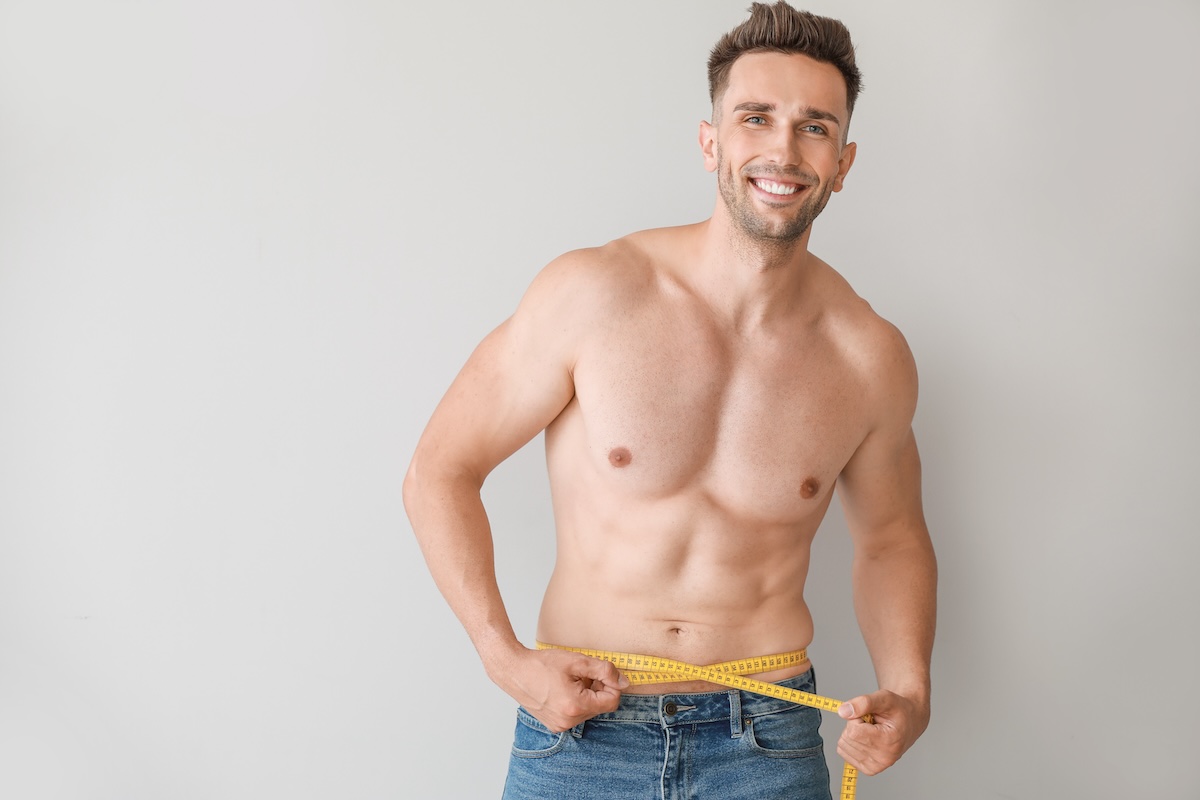 Man holding tape measure for weight loss